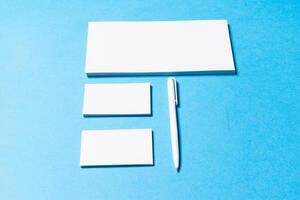 blank office objects organized for company presentation on blue paper background photo