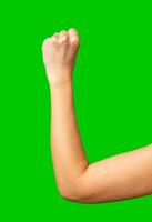 Fist raised in determination against a bright green background showing strength and motivation photo