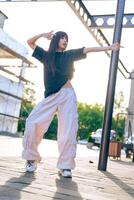 Dancer showcases urban choreography in sunlight near construction site with modern architecture photo