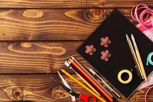 Creative crafting workspace with various tools laid out on a wooden table for a fun project photo