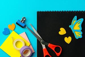 Crafting with colorful materials and fun tools on a bright blue background photo