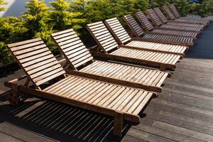 number of empty sunbeds at the pool early in the morning photo