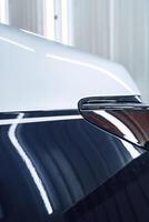 Shiny car detail showcasing sleek lines and reflective surfaces during a professional detailing session photo