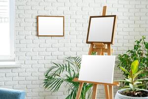 Art studio setup with empty canvas and fresh greenery surrounded by minimalist decor photo