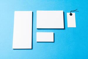 blank office objects organized for company presentation on blue paper background photo