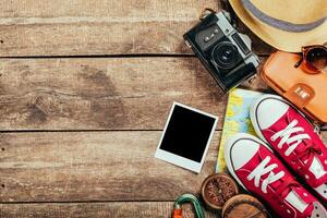 Set of trip stuff on wooden background photo