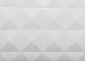 Geometric pattern of white triangular shapes on a textured surface in a contemporary design setting photo