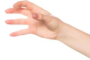 Hand reaching out with five fingers extended near a blank background during daylight photo