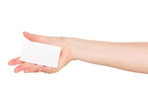 Person extends hand holding a blank card against a white background in a minimalist setting photo