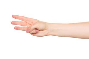 Hand gesture with three fingers raised during a conversation at a casual gathering in a bright indoor setting photo