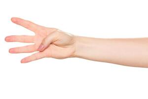 Hand demonstrates a counting gesture with four fingers extended, isolated on white background photo