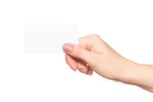 Person extends hand holding a blank card against a white background in a minimalist setting photo