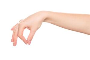 Hand demonstrating a playful gesture with a rubber band stretched between fingers indoors photo