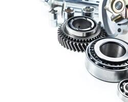 Detailed close-up of mechanical components and bearings arranged on a work surface in an industrial setting photo