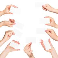 Hands presenting blank cards against a plain white background in a creative display of ideas and collaboration photo