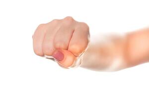 Fist held firmly in a gesture of determination with a soft focus background photo