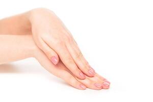 Elegant hands with manicured nails arranged gracefully on a white background showcasing beauty and tranquility photo