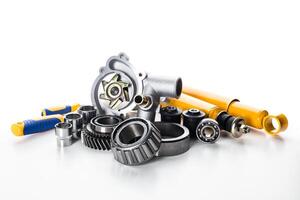 Various automotive parts and components arranged for display in a studio setting photo