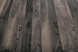 Detailed view of dark wood grain texture with unique patterns and shades in a natural setting photo