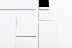 Blank canvases and a smartphone on a white table, ready for creative inspiration during the afternoon hours photo
