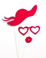 Fun red paper props for a creative photo booth at a festive event or party