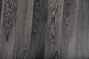 Dark wood texture with intricate grain patterns in a close-up view showcasing natural beauty and elegance photo