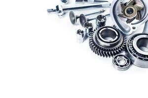 Various mechanical components and tools arranged on a clean surface for industrial purposes photo