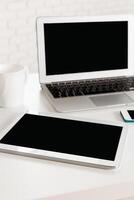 Modern workspace with digital devices showcasing productivity and organization in a minimalist setting photo