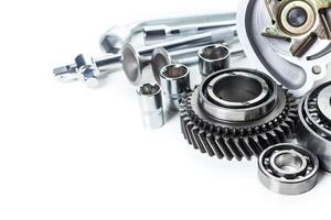 Collection of mechanical components and tools arranged neatly on a white background for repair and maintenance work photo