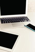 Multiple digital devices on a clean workspace, emphasizing modern technology and connectivity in everyday life photo