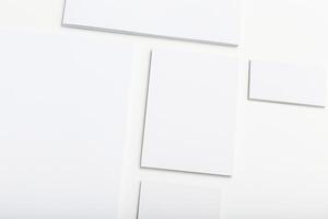 Blank sheets of paper arranged in a creative pattern on a white background during daylight hours photo