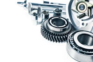Detailed view of various mechanical components arranged on a clean surface with bright lighting photo