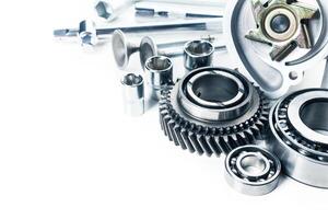 Various metallic mechanical parts arranged for maintenance or assembly in a workshop setting photo
