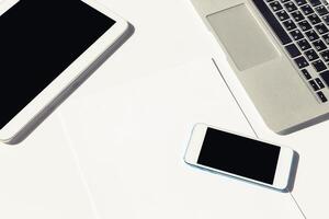 Devices arranged on a minimalistic desk with a focus on technology and productivity tools photo