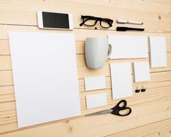 Workspace setup with stationery and tech tools for creative projects on a wooden table photo