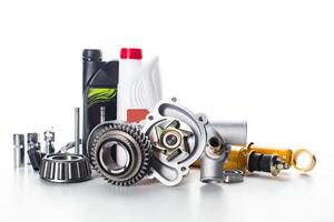 Various automotive components and tools arranged on a white background for garage use and maintenance tasks photo