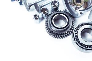 Various automotive engine components arranged on a clean surface for inspection and maintenance in a workshop setting photo
