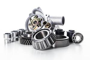 Collection of various mechanical parts and components arranged for display in a clean, bright setting photo