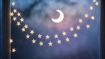 Twinkling string lights hang near a crescent moon at twilight with a serene backdrop of an evening sky photo