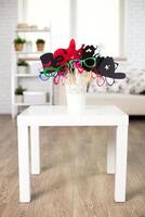 Fun photo booth props displayed in a charming living room setting for gatherings and celebrations