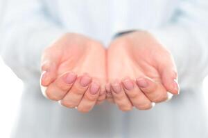 Open hands ready to receive help during a community event in a neutral-colored setting photo