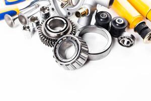 Various mechanical parts and tools for automotive repair displayed on a clean surface photo