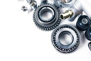 Various mechanical parts and components arranged neatly on a white surface for inspection and maintenance purposes photo