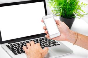 Technology tools at work with a laptop and smartphone in a modern workspace environment photo