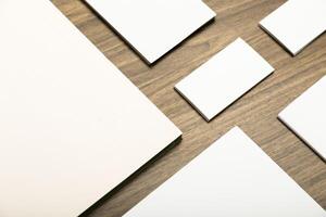 Blank stationery arranged on a wooden surface for creative design and artistic projects photo