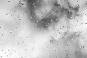 Raindrops on a window create a tranquil atmosphere during an overcast day photo