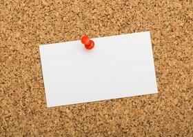Notice board with blank paper ready for messages or announcements in a workspace photo