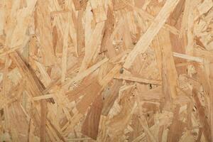 Wooden texture showcasing oriented strand board with visible fibers and layers for construction and design projects photo