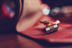 Stylish cufflinks resting on a textured surface, showcasing intricate design and elegance during an upscale event photo