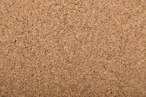 Natural cork board surface showcasing a textured pattern ideal for pinning notes and reminders during office hours or creative projects photo